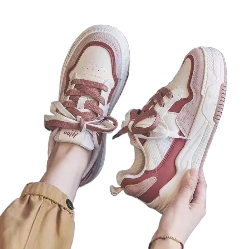 Beige and pink low-top platform sneakers with a rubber sole on a white background
