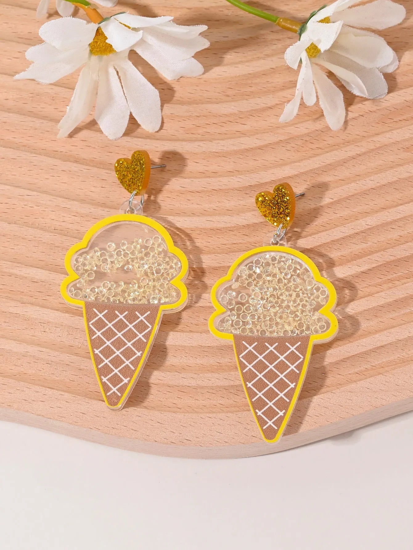 Colourful acrylic novelty earrings shaped like fruits and desserts including cherry, strawberry, and ice cream.