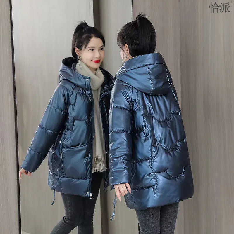 Women's loose fit hooded winter jacket in green colour showing long sleeves and thick insulation