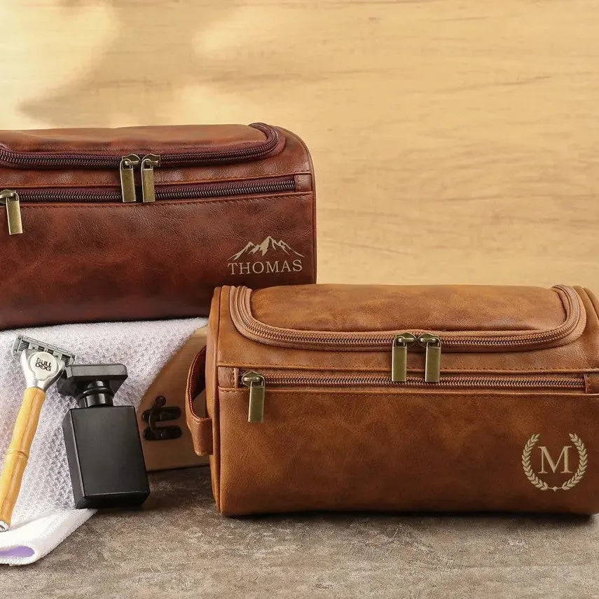 Men's neutral-coloured PU travel organiser with multiple compartments open showing interior layout