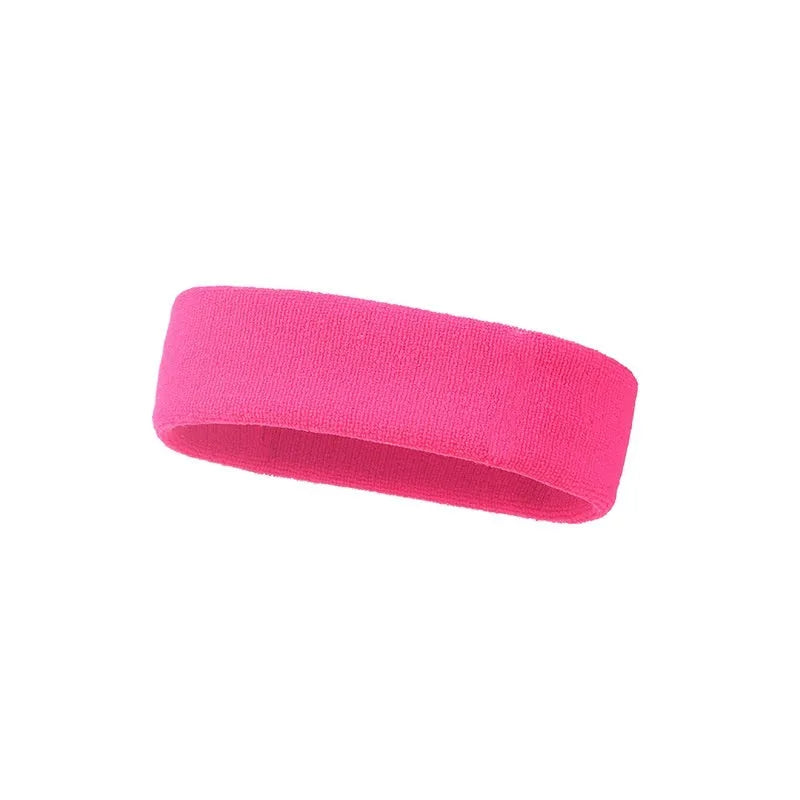 Elastic solid colour sports sweat band in black, shown on a forehead.