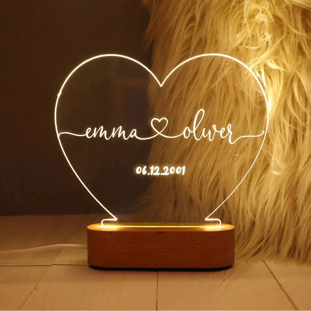 Custom engraved acrylic LED night light showing illuminated personal names and dates