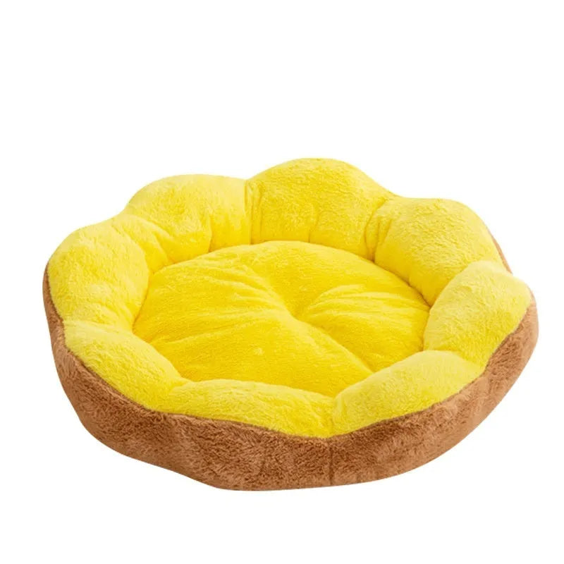 Round plush cat bed with removable cover in brown gray colour, shown in a home setting.