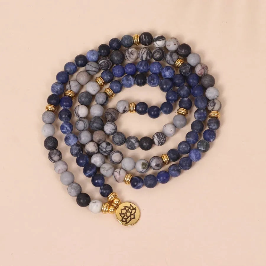 Layered multi-strand bracelet with blue patterned network stone beads and alloy toggle clasp