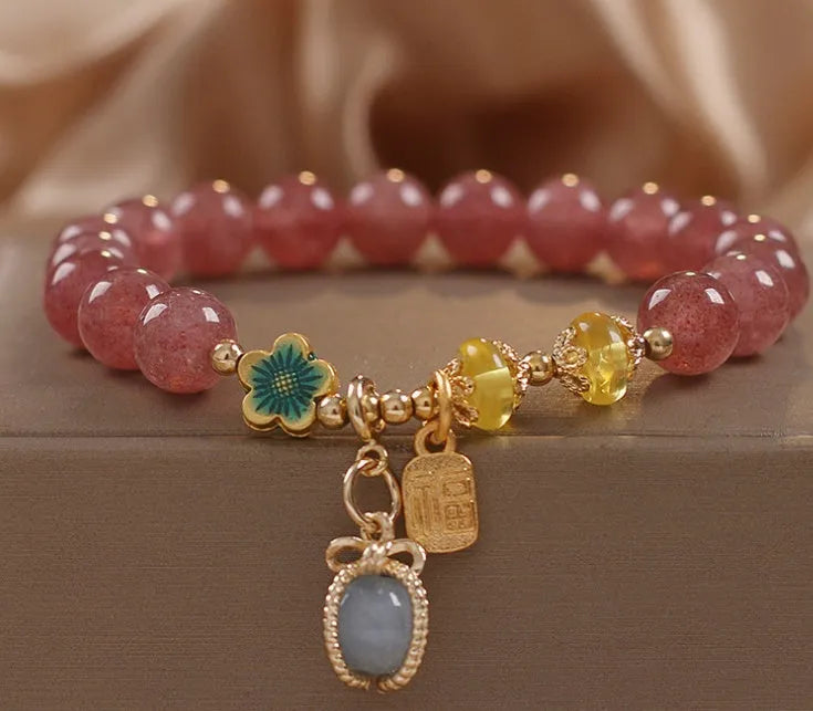 Red women's beaded bracelet with natural strawberry quartz stones and sparkling rhinestone accents.
