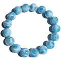 Blue handmade bodhi and pearl bracelet in Maillard style on a neutral background.