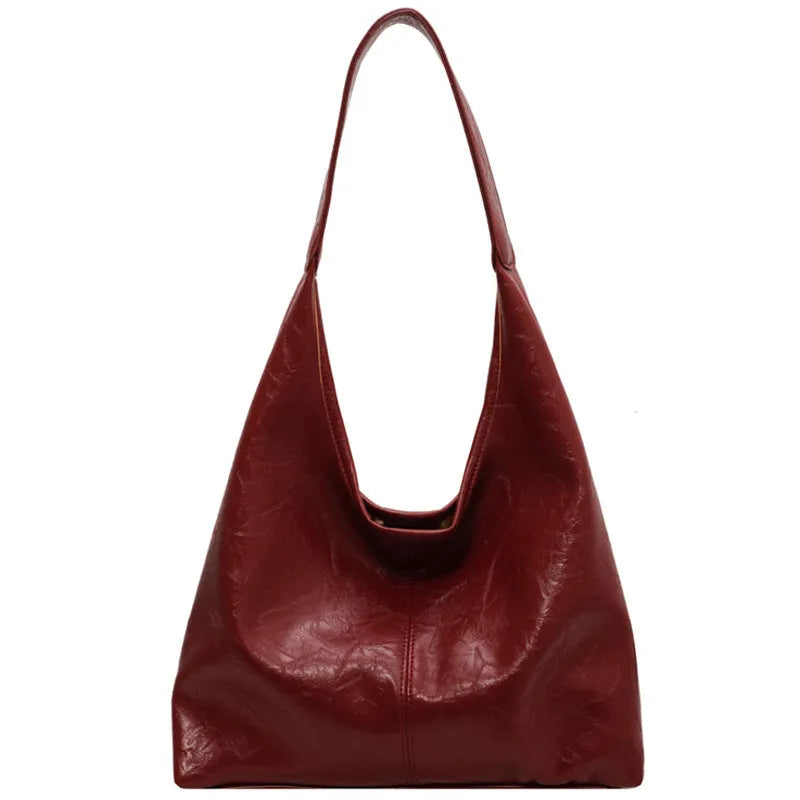 Soft leather shoulder bag in street style with sandwich pockets, shown in multiple colour options.