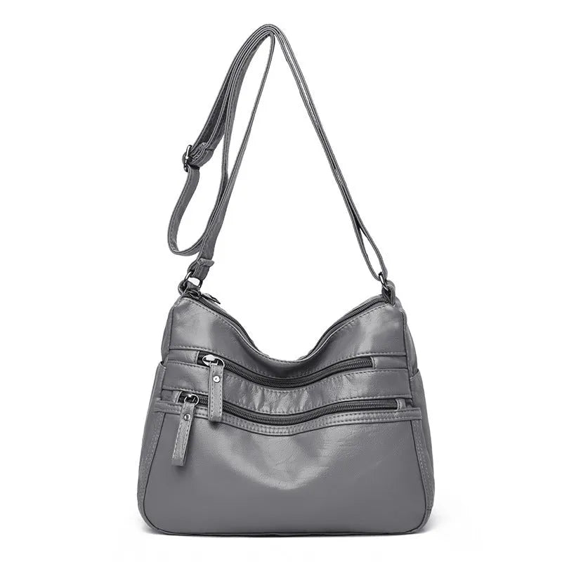 Women's washed leather crossbody bag in solid colour, retro messenger style with adjustable strap and soft handle