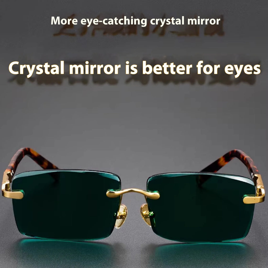Dark green frameless crystal sunglasses with case and cleaning cloth on a solid background.
