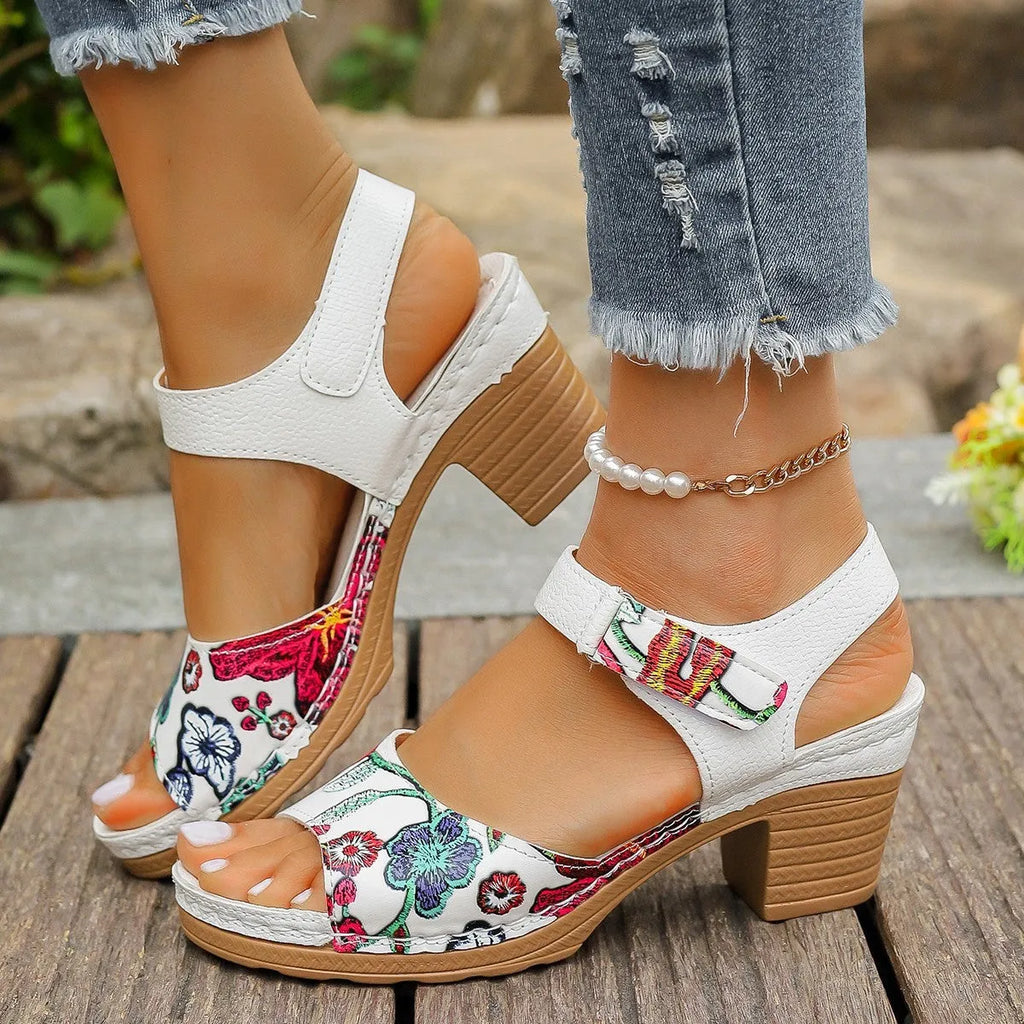 White women's high heel sandals with an adjustable velcro buckle strap on a rubber sole.