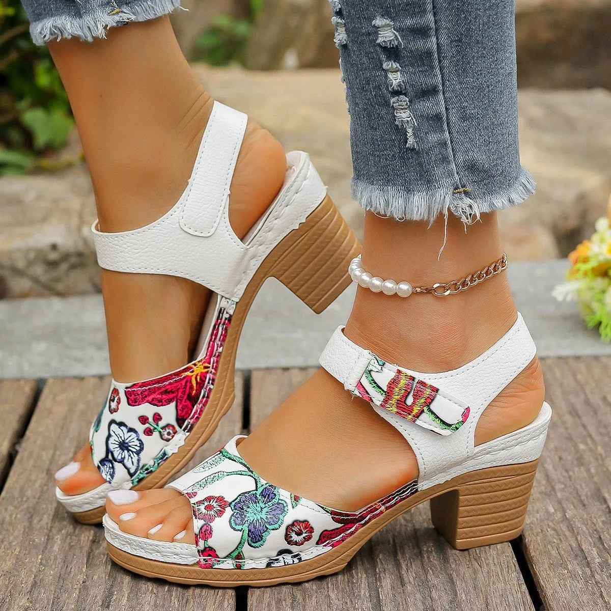 White women's high heel sandals with an adjustable velcro buckle strap on a rubber sole.