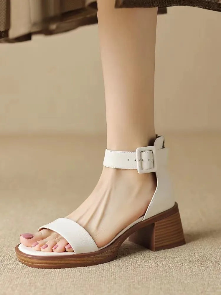 Women's white retro platform high heels with an ankle strap and round toe.