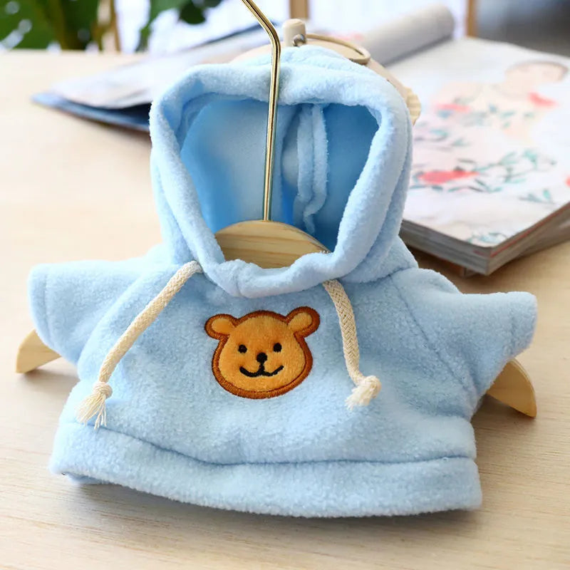 A selection of dog sweaters and hoodies in blue, pink, red, yellow, brown, and grey bear designs, shown in medium and large sizes.