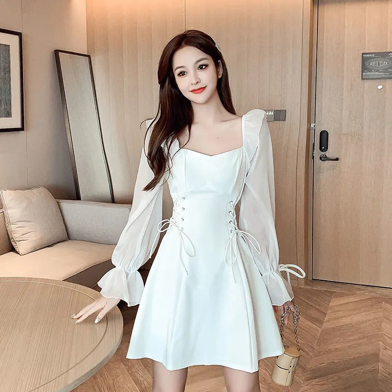 White chiffon patchwork dress with long sleeves and a waist-slimming silhouette on a woman
