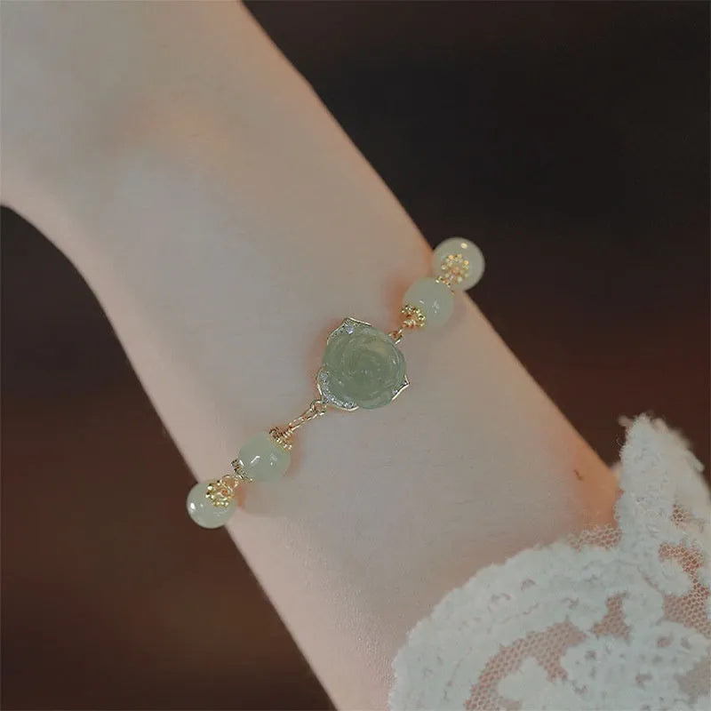 Hetian jade women's bracelet with rose flower design and 14K gold gilding details