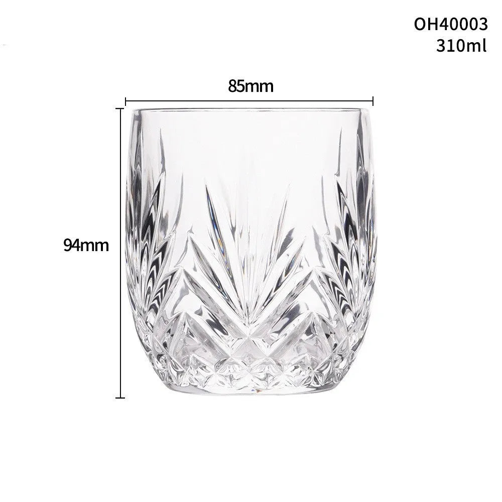 Clear thick-bottom whiskey shot glass with 301-400ml capacity on a table.