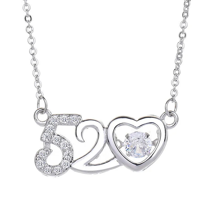 Silver love heart-shaped necklace with crown and bow decoration on clavicle