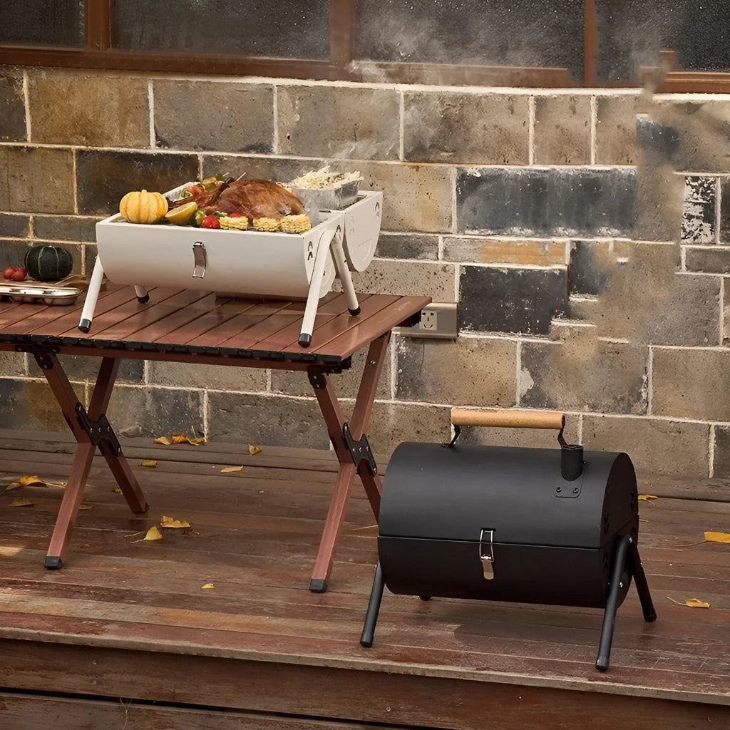 White portable barbecue grill with folding design and detachable carbon tanks for frying and baking.