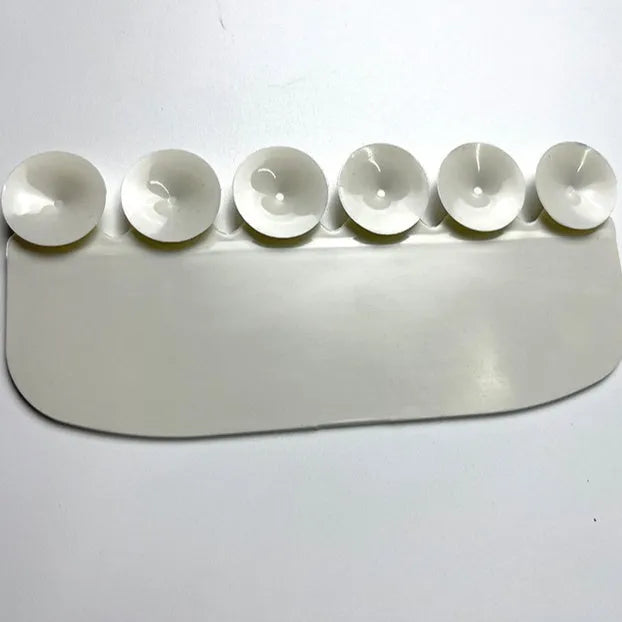 White PVC children's toilet training splash guard placed on a toilet seat.