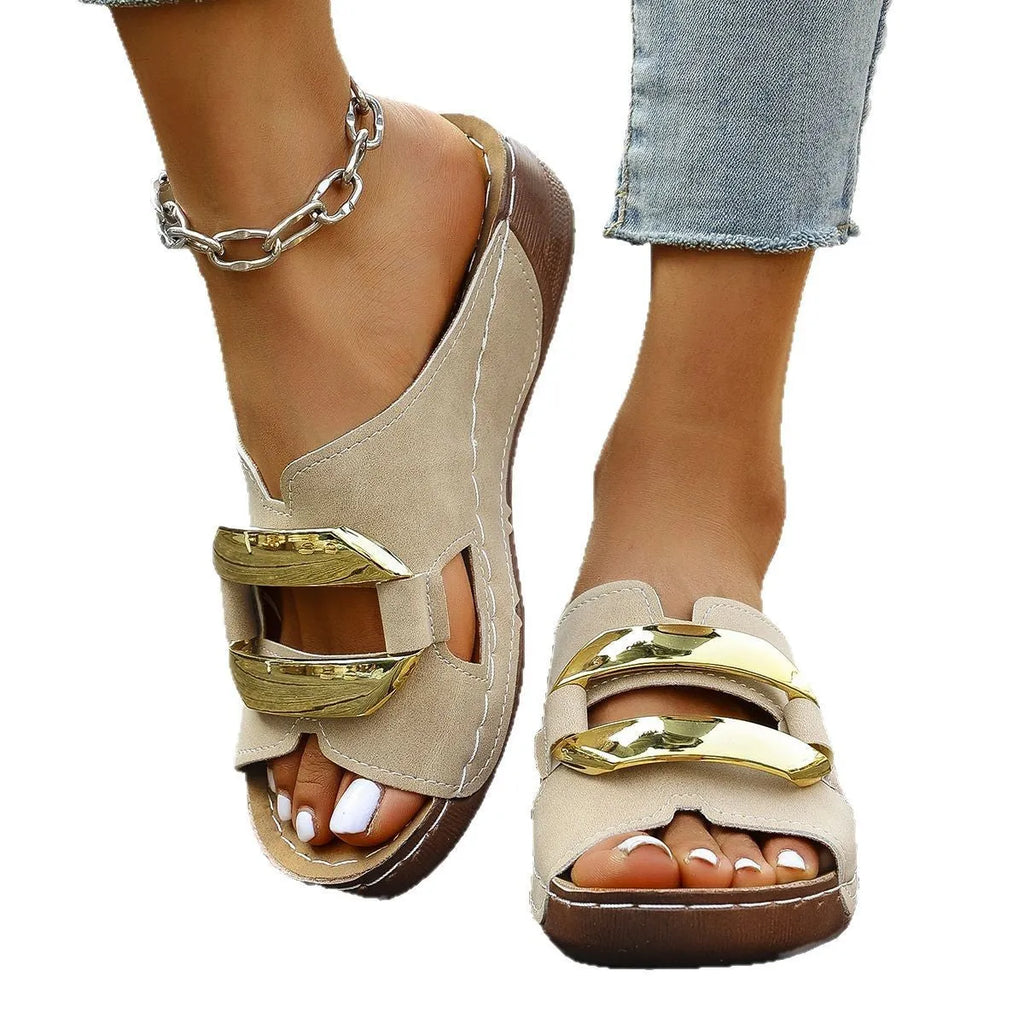 White Roman style platform sandals with flat heel and metal detail on a rubber sole.