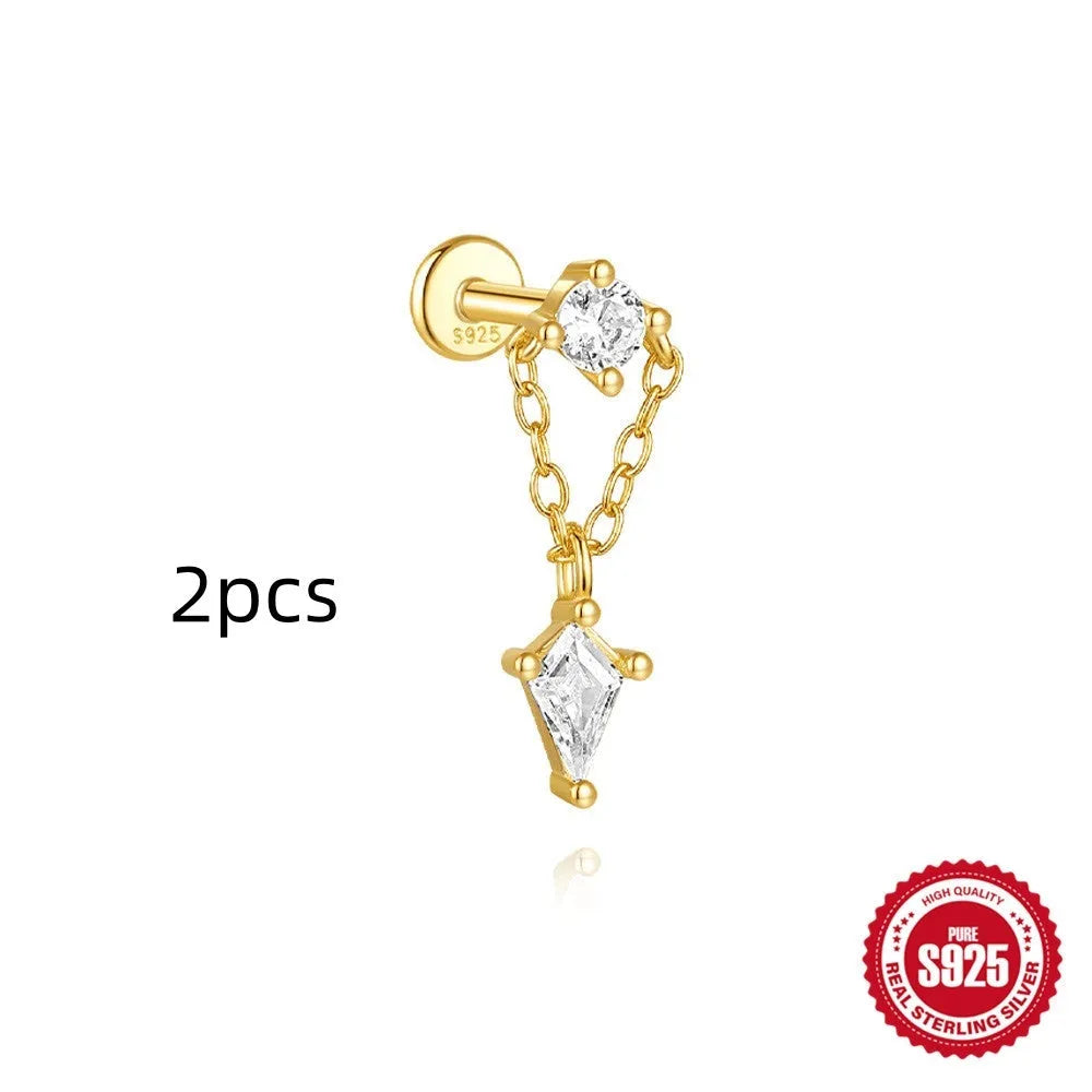 Geometric kite-shaped sterling silver earring with rhinestone head and gold chain tassel.