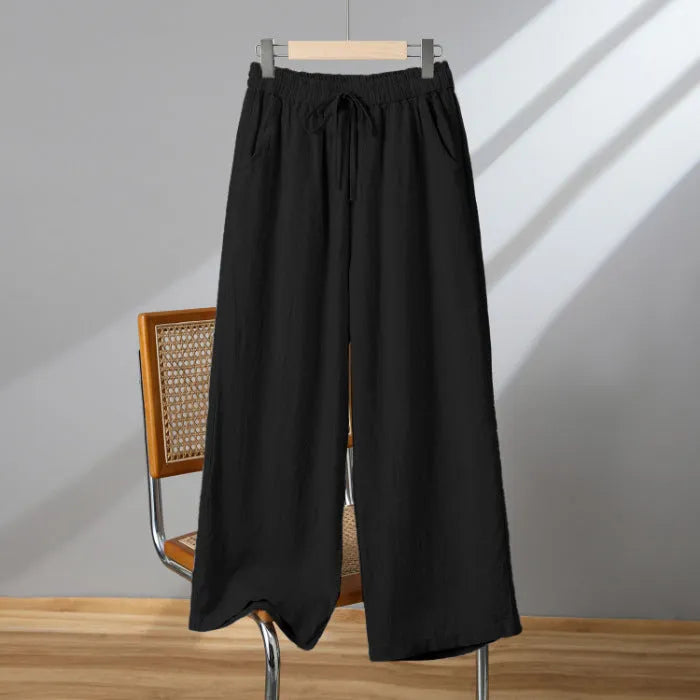 Women's apricot straight-leg casual trousers with an elastic lace-up waistband on a hanger.