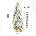 24-inch plastic Christmas tree with PE simulation snow spray effect and built-in lights on desktop