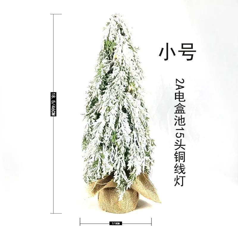 24-inch plastic Christmas tree with PE simulation snow spray effect and built-in lights on desktop