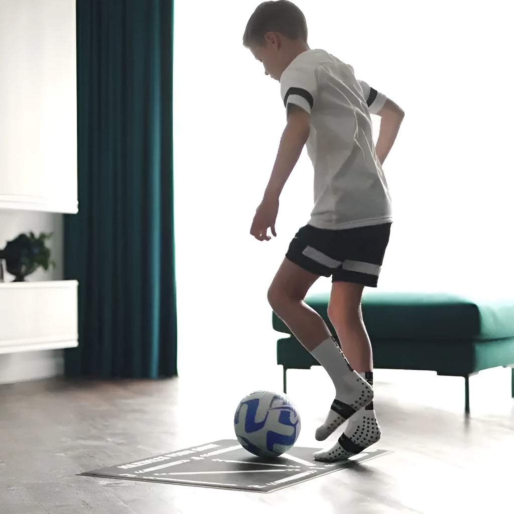 Black football training mat measuring 60 by 90 centimetres with non-slip surface