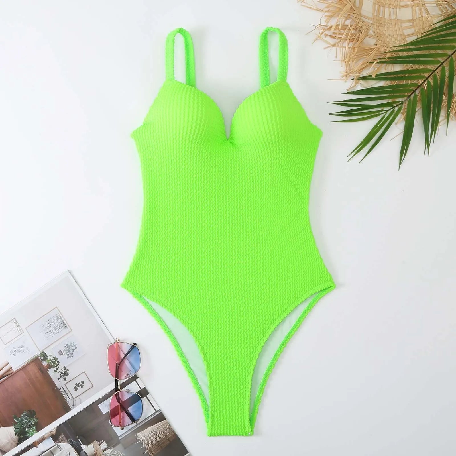 Women's one-piece swimsuit with sunken stripe pattern in polyester fabric, shown in multiple colour options