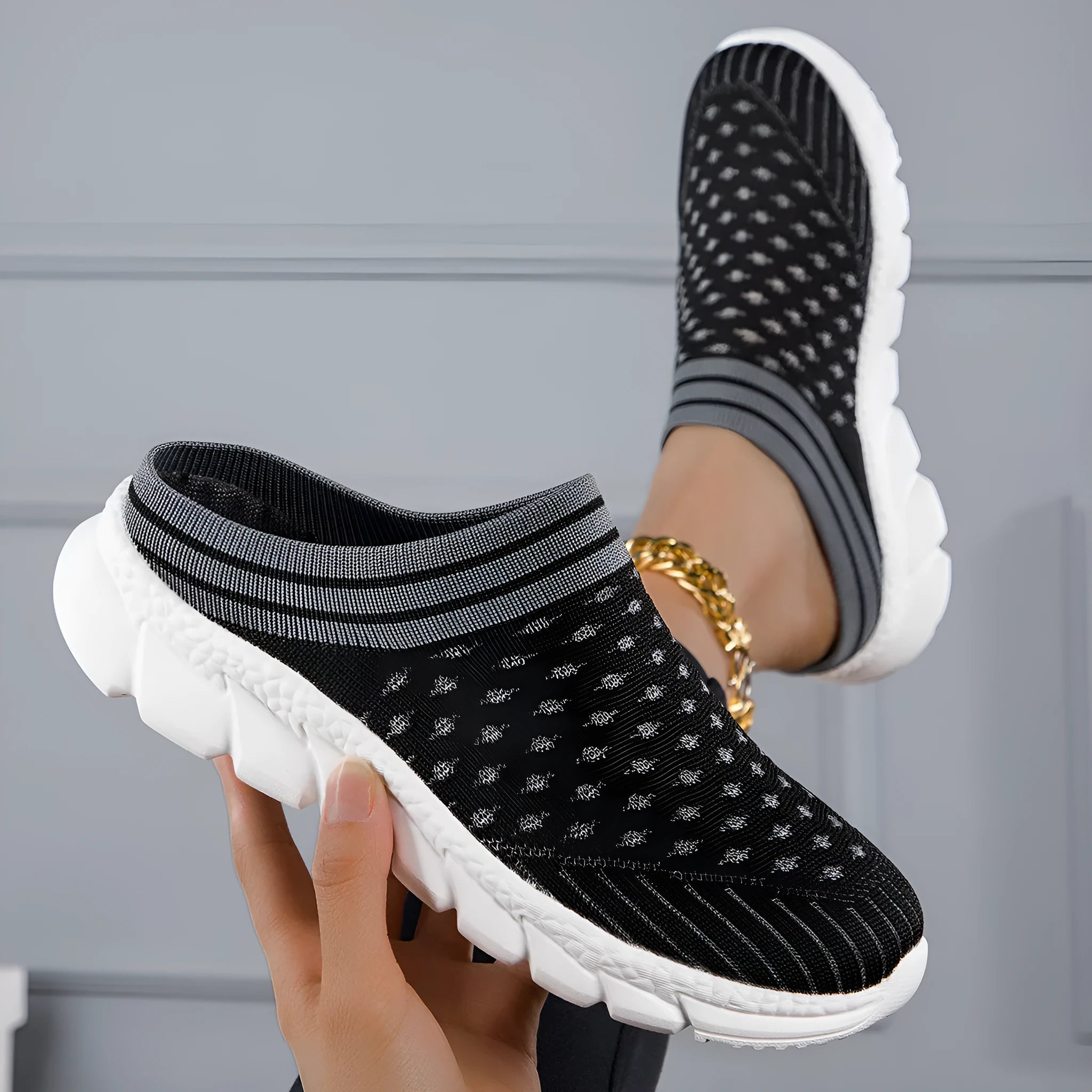 Women's black Flyknit semi slippers with hollowed-out sewing line detail and viscose sole