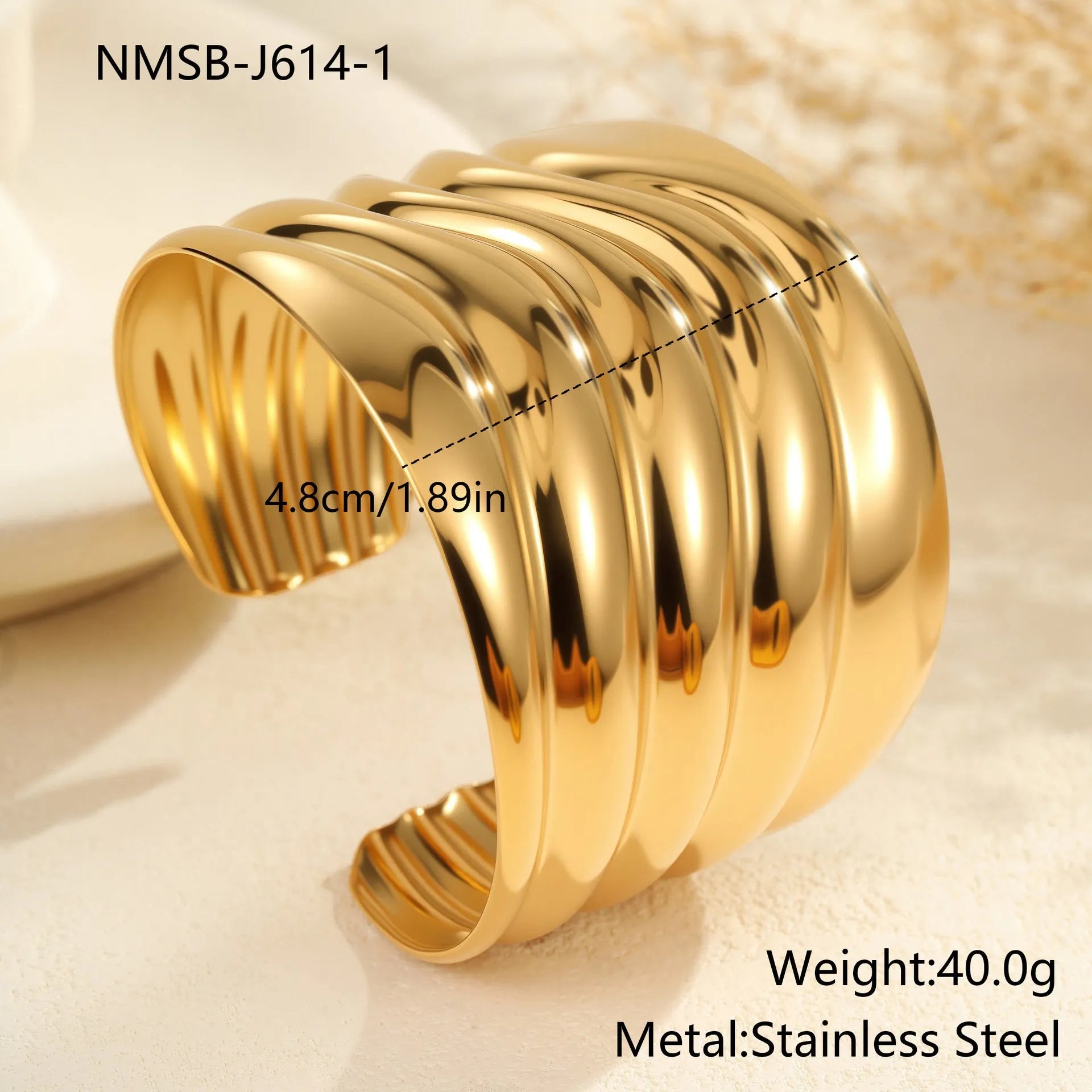 Women's wide fashion bracelet with wave design in gold-plated stainless steel
