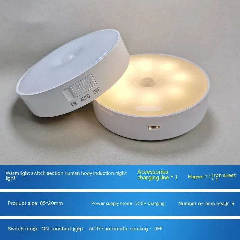Compact round motion sensor LED night light with USB charging cable and adhesive mounting tape