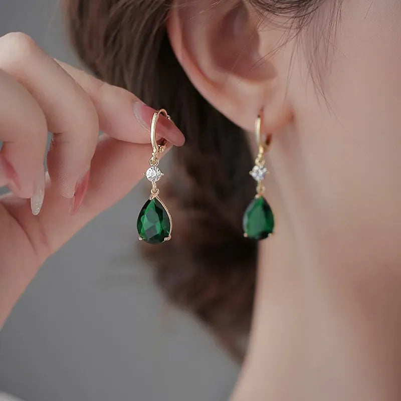 Green geometric teardrop alloy earrings showing structured design from multiple angles