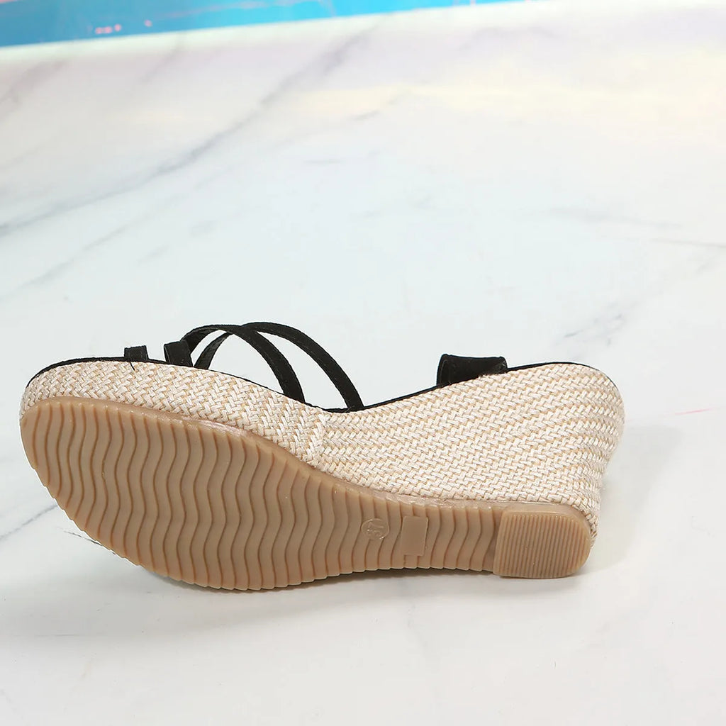 Women's wedge sandal with fish mouth toe design in black cloth upper.