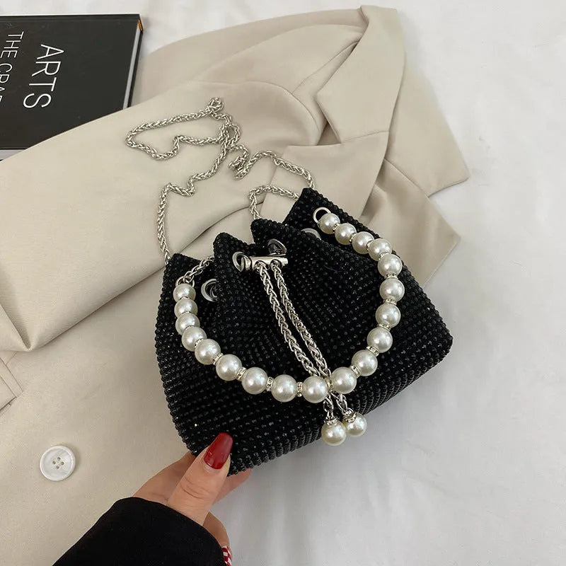 Diamond pattern crossbody bag with chain strap in bucket shape showing internal organisation compartments