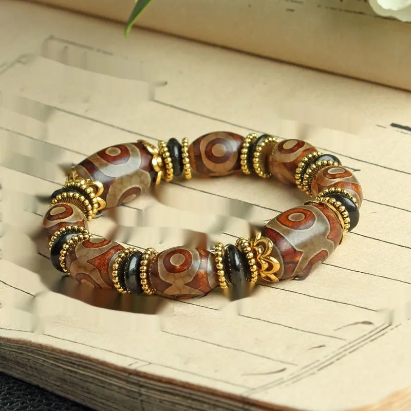 Agate Tibetan dzi bead bracelet with three-eye design and polished finish