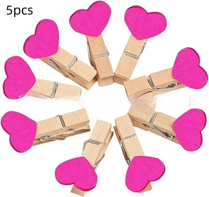 Five solid wood heart-shaped clips in different colours showing handmade construction details