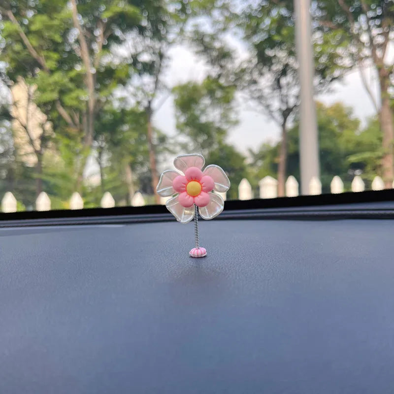 Small colourful plastic swing car decoration ornament in blue, green, pink, purple, or yellow.