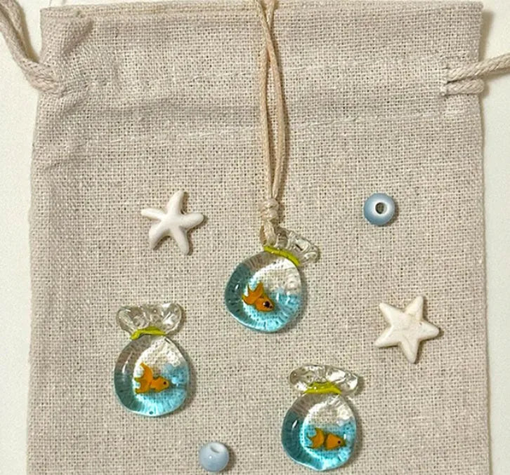 Women's necklace with a coloured glaze skirted joker pendant on a cotton and linen clavicle chain.