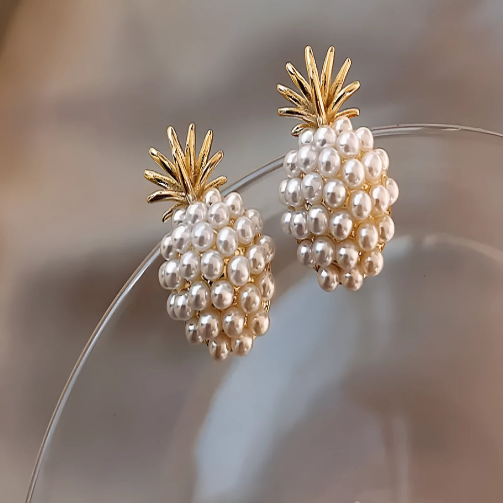 Gold Korean-style alloy earrings with pineapple starfish design and pearl-coloured gem inlays.
