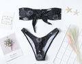 Black nylon one-piece swimsuit with backless design and waterproof print pattern