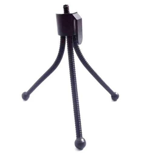 Small black iron mini tripod with ball head and folded legs on a table