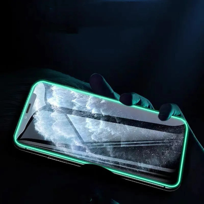 Luminous full cover tempered glass screen protector glowing on an iPhone in a dark setting.