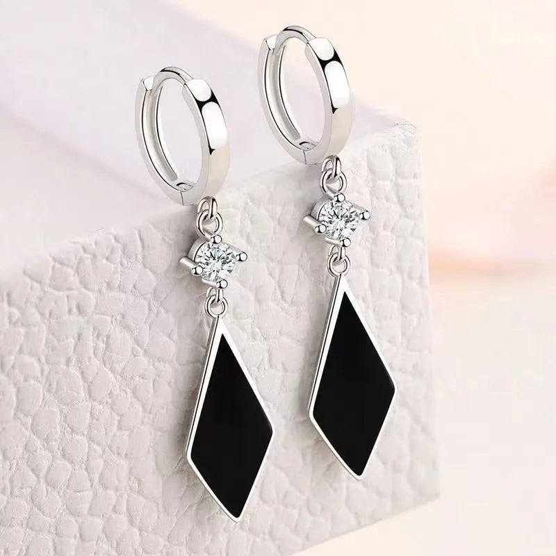 A pair of silver-coloured vintage geometric diamond earrings with an ear clip fastening.
