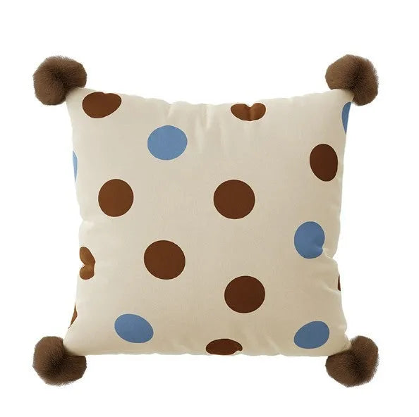 Blue cartoon animal printed cushion on a grey sofa showing removable cover.