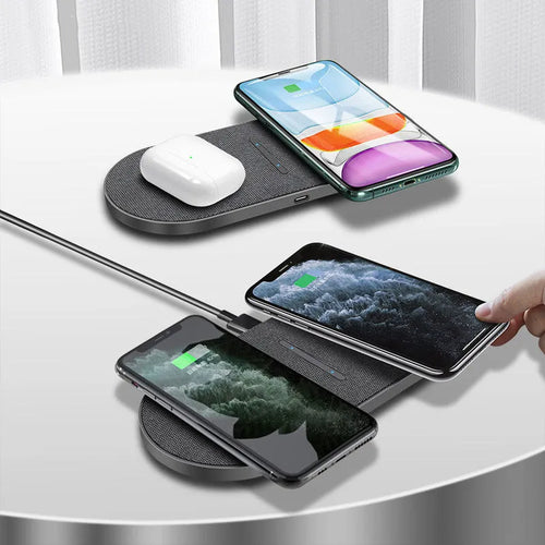 Black 10W dual wireless charging pad set with LED lights, shown charging two smartphones.