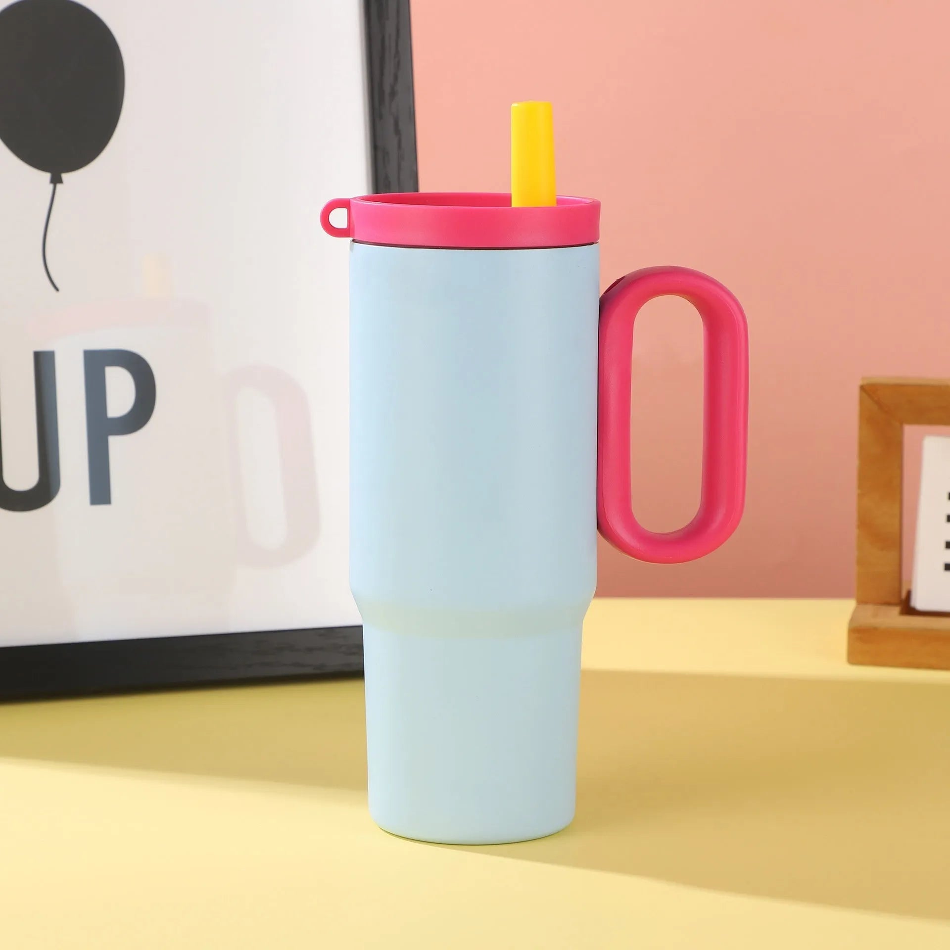Large insulated straw drinking cup with a carrying handle in various colours.