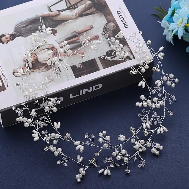 Bride's long hair band with pearls and crystals on a gold-coloured wire, shown coiled.