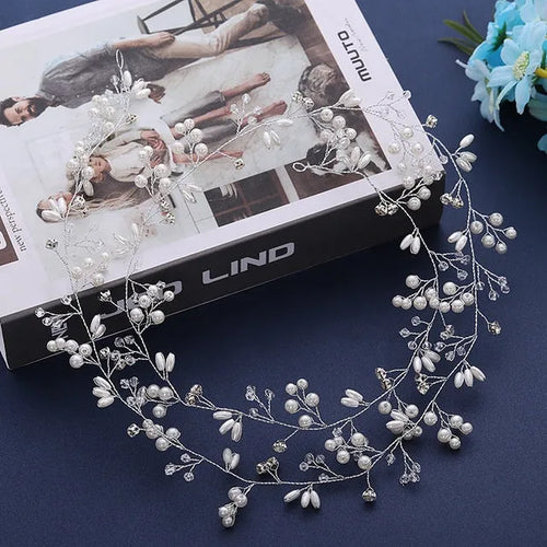 Bride's long hair band with pearls and crystals on a gold-coloured wire, shown coiled.